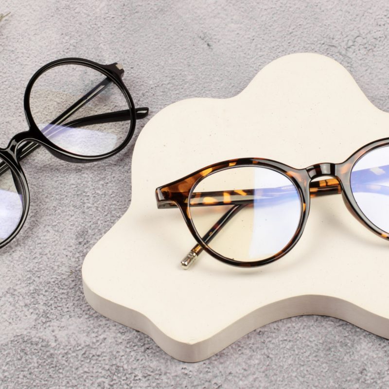 Proposal for the sale of an optics store. Optics store. Two pairs of plastic-framed glasses.